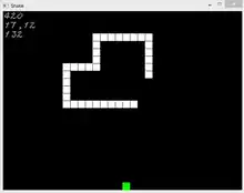 snake made of white squares going towards an apple represented by a green square - the score and other data are at the top right in white