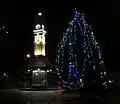 Oakwood Clock at night with Christmas Tree