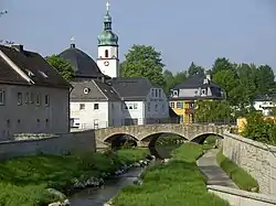 Schwesnitz River in Oberkotzau with the Protestant Church of Saint James in the background