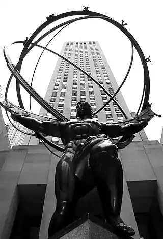 Bronze Atlas statue, depicting Atlas the titan in Ancient Greek mythology, bent over holding up a wire sphere representing Earth. Located at Rockefeller Center, seen from below.