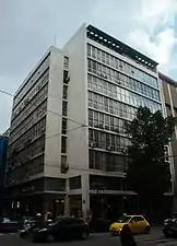 An office building on Stadiou Street designed in c. 1960 by Emmanouil Vourekas and Periklis Sakellarios.