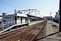 View of the JR East platforms looking south, with the former platform 1 on the right, and the Tōbu platforms and former toilet block on the left, February 2012