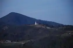 St. Lawrence's Church in Okroglice. Big Kozje Hill in the background.