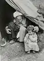 Old and young in the entrance of a tent, 1948.