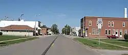 The downtown area of a small town bisected by a highway.