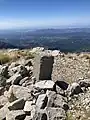 The summit marker at the top of Olenos Peak.