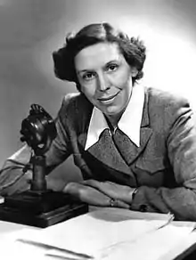 portrait photo of Olive Shapley at a BBC microphone