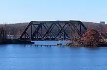 A steel truss bridge crossing a narrow channel of water.