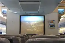 A television screen with the view of the city from the aircraft's nose camera