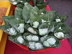 Klepon; the green flecks within the rice derive from glutinous rice flour mixed with sweet potato and flavored with pandan.