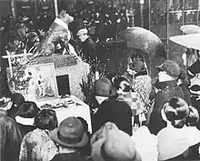 Crowd of people gathered around the (1st) statue of Hachikō in honor of the one year anniversary of his death on March 8, 1936.