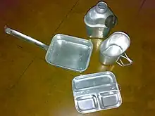 A mess kit with a combination plate (bottom)