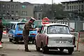 East German officer monitors traffic returning to East Berlin, November 1989.