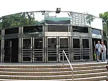 A grey-clad circular entrance at street level, now demolished