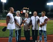 Orleans, singing the national anthem at Fenway Park in July 2006. Left to right: Charlie Morgan, Lance Hoppen, Larry Hoppen, Dennis "Fly" Amero, Lane Hoppen