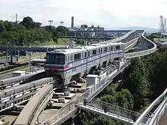 Exterior of a Osaka Monorail 2000 series train running along its track