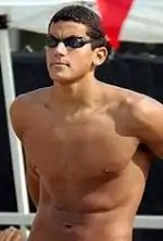 An image of standing topless man with black goggles