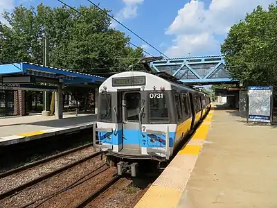 A rapid transit train at a surface-level station