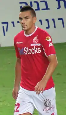 Ovidiu Hoban on the pitch, in a red jersey