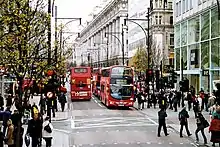 Looking west along Oxford Street, with two buses and Selfridges department store