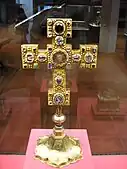 Golden cross on a pedestal with inlayed gems