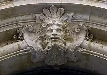 Mascaron with a Baroque palmette above it, on the façade of the Hôtel d'Aubray, Paris