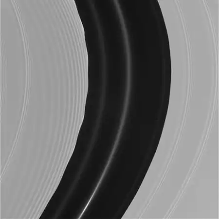 Pan's motion through the A ring's Encke Gap induces edge waves and (non-self-propagating) spiraling wakes ahead of and inward of it. The other more tightly wound bands are spiral density waves.