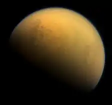 Natural color visible-near infrared view of Titan showing its north polar seas and lakes at upper left.