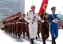 The tri-service color guard leading the battalion during a parade.