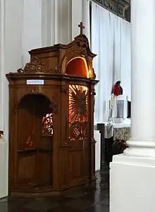 A confessional in the Roman Catholic Visitationist Church with the light on to signal a priest is waiting inside, Warsaw, Poland