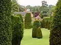 View of the house and yew trees from The Mount