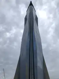 The glass elevator shaft in the middle overlooking downtown Kuala Lumpur from Jalan Hang Jebat