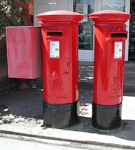 Father and daughter pair: George VI and Elizabeth II pillar boxes at Bembridge Post Office Isle of Wight. One was for local mail and the other for off-island post.