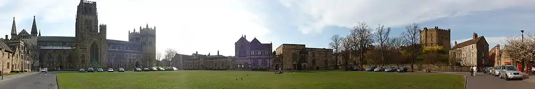 Panoramic view of Palace Green, showing Durham Cathedral to the left, the old University Library in centre, and University College and Owengate to the right.