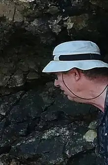 Jan Smit looking at rocks
