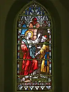 Stained glass rendition of Zacchaeus receiving Jesus into his house.