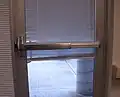 "Crash bar" handle installed on a glass exterior door