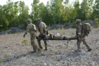 Pararescue specialists from the 103d Rescue Squadron, NY, evacuate a casualty during a Combat Search & Rescue exercise at Northern Strike 2018