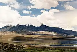 The white lava domes and a black lava flow are visible above the lake