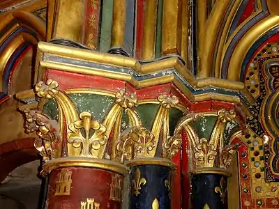 Lower chapel, column capital on reverse of west front. Castles and fleur-de-lis symbols seen here on the columns,  are found throughout the chapel, relating to the two royal families from which Louis IX descended (the Capet fleur-de-lis through his father, Louis VIII of France, and the Castile castle through his mother, Blanche of Castile).