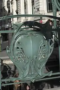 Railing escutcheon with "M", Quatre-Septembre