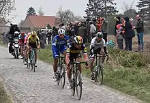 Lampaert leading Gilbert, Sagan with van Aert, Vanmarcke and Politt closely following at the Mons-en-Pévèle pavé sector