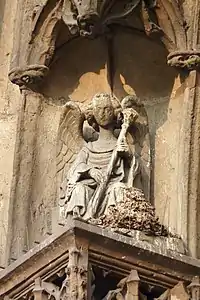 Sculpture of angel with trumpet, south portal