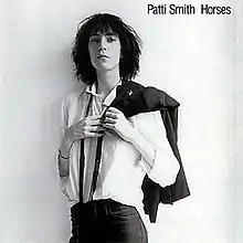 The album cover features a black-and-white photograph of Patti Smith slinging a jacket over her shoulder.