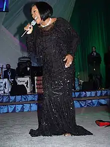 A woman in a black dress singing
