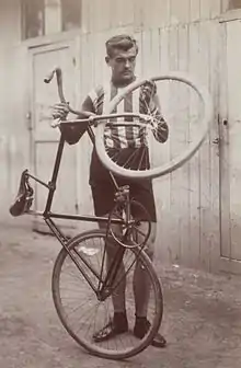 A man holding up a bike