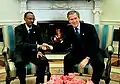 One of many hand-shake photos in front of the fireplace. President George W. Bush sitting to the viewer's right, the guest (Paul Kagame, President of Rwanda) to the left, March 2003. One of the rare images where there is fire in the fireplace.