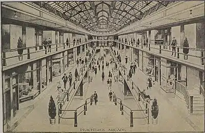 A monochromatic image of the atrium area of the interior of a shopping arcade