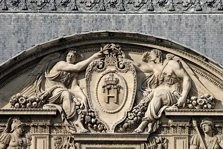 Renaissance cartouche in a pediment of the west facade of the Cour Carrée of the Louvre Palace, Paris, designed by Pierre Lescot, 16th century
