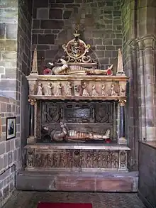 Tomb of two Sir Edward Littletons, father and son. East wall of north chancel aisle. Lower stage: Sir Edward Littleton (d. 1610) and his wife Margaret Devereux. Upper stage: Sir Edward (d. 1629), and his wife Mary Fisher. Their son, also Sir Edward, became the first baronet in 1627.